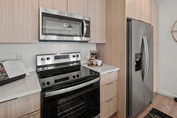 A kitchen with a stove and a refrigerator